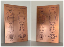 Copper plaque with engraved detailed engineering drawing.
