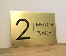 Brass house plaque with black engraved text reading '2 MELLOR PLACE' - 3Dprintshed