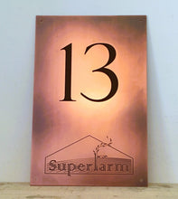 Copper business sign with engraved logo and branding.