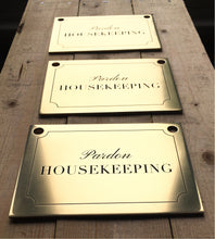 Three brass housekeeping signs on a wooden surface - made by 3Dprintshed