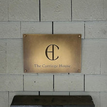 Brass plaque with 'The Carriage House' logo on a stone wall - made by 3Dprintshed