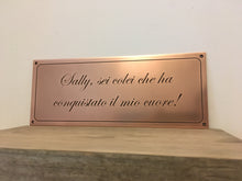 Copper plaque with engraved Italian text in a script font.