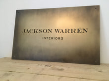 Custom brass interior design plaque with aged finish